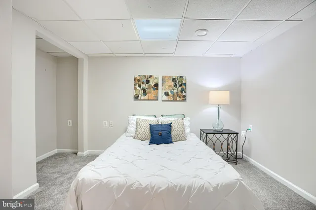 a large bed sitting in a bedroom and a lamp