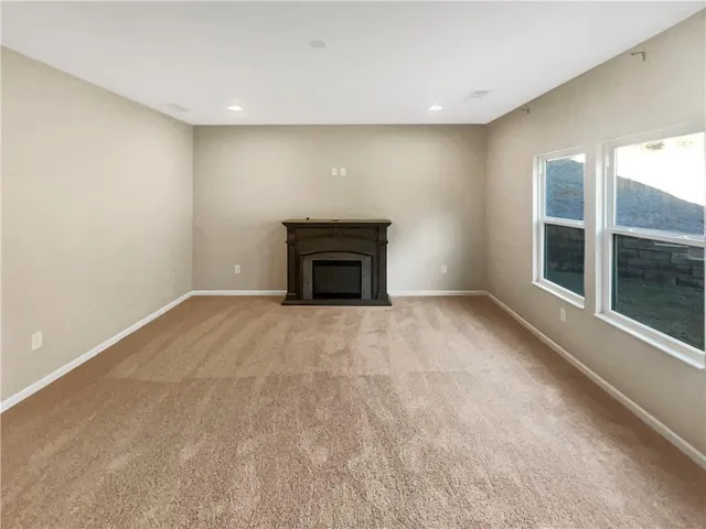 an empty room with a fireplace