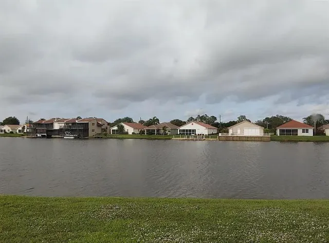 a view of a lake with houses in the back