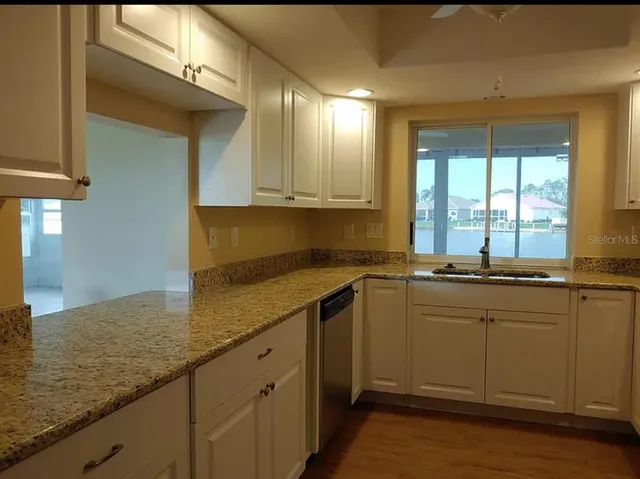 a kitchen with a sink and cabinets