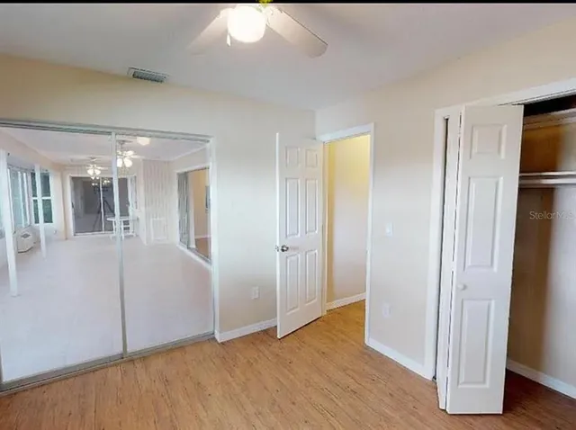 a view of livingroom with hardwood floor and a bathroom
