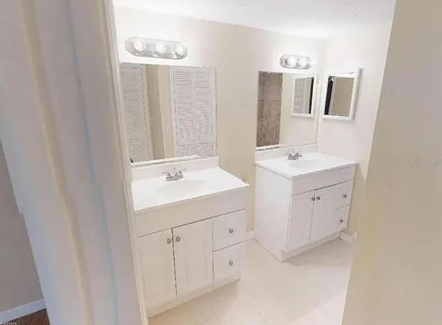 a bathroom with a double vanity sink and mirror