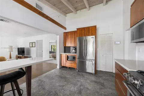 a kitchen with stainless steel appliances a refrigerator a stove a sink dishwasher and a refrigerator with wooden floor