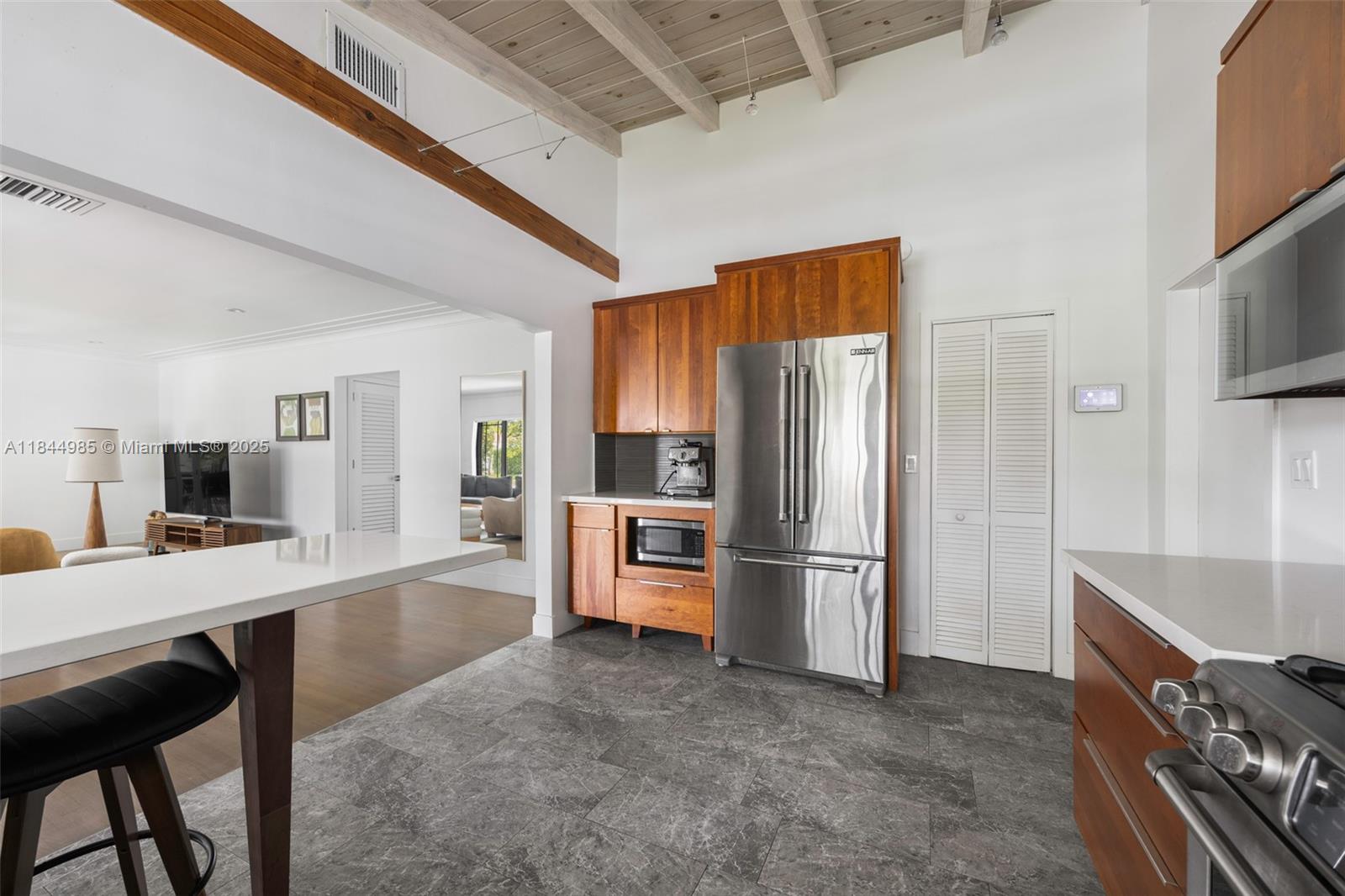 1080 Northeast 86th Street Miami, FL 33138 - Photo 14 of 25 a kitchen with stainless steel appliances a refrigerator a stove a sink dishwasher and a refrigerator with wooden floor