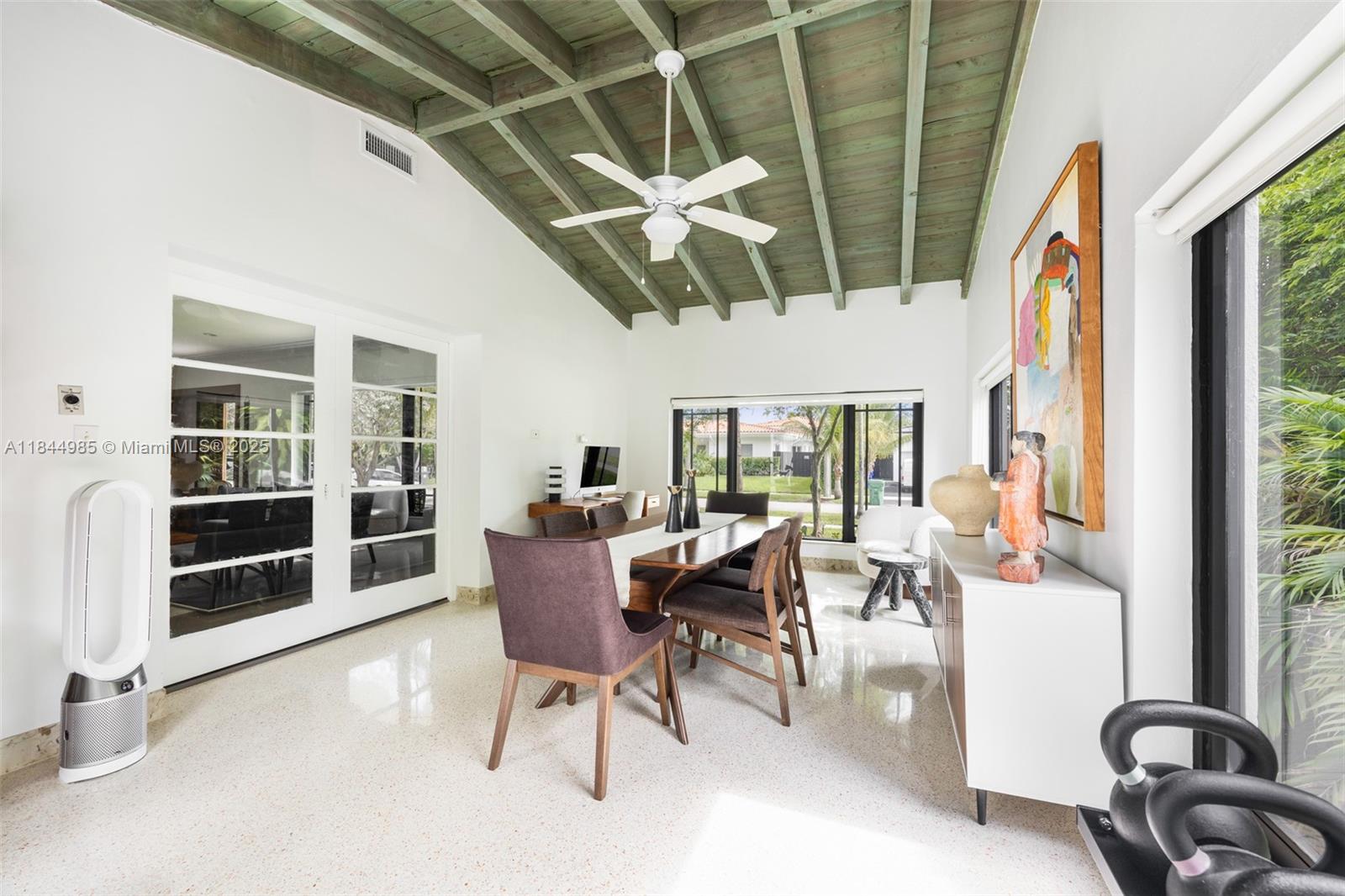 1080 Northeast 86th Street Miami, FL 33138 - Photo 15 of 25 a dining room with furniture water view and a floor to ceiling window