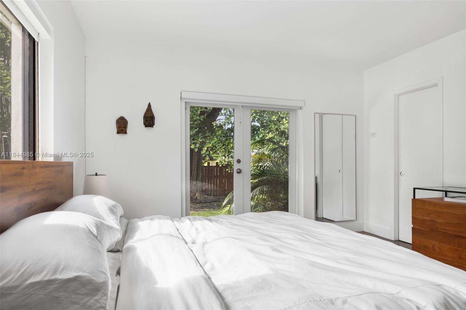 1080 Northeast 86th Street Miami, FL 33138 - Photo 19 of 25 a bedroom with a bed and a window