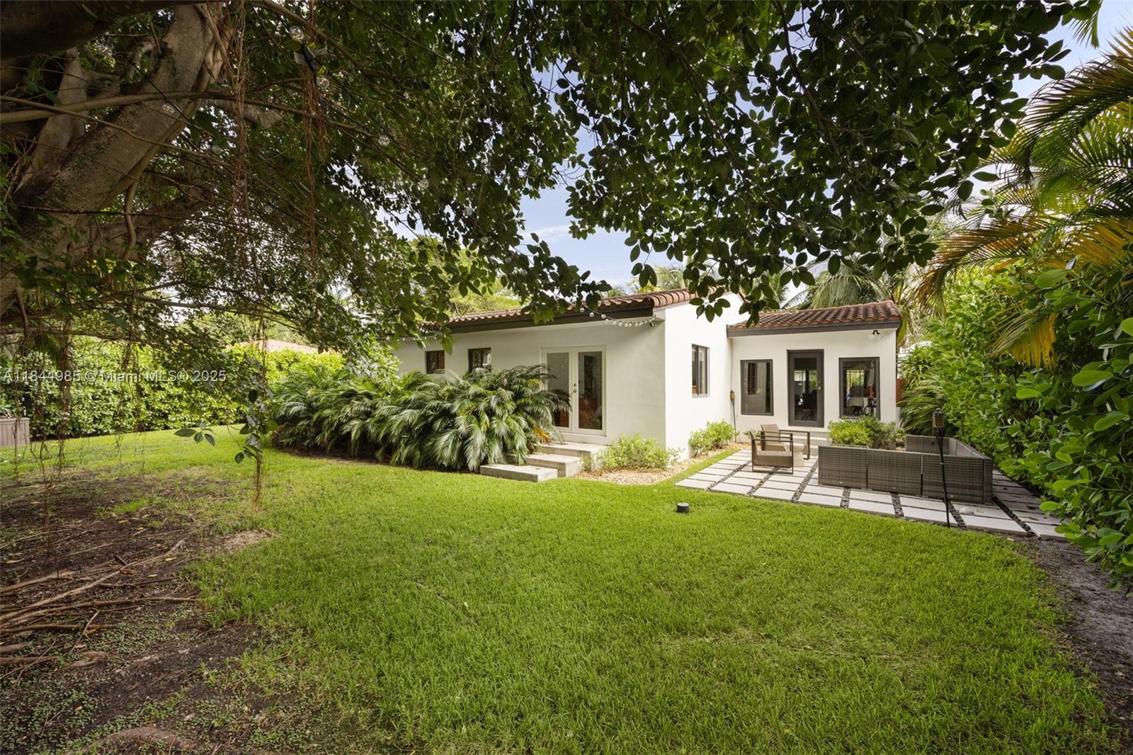 1080 Northeast 86th Street Miami, FL 33138 - Photo 23 of 25 a view of a house with backyard and sitting area
