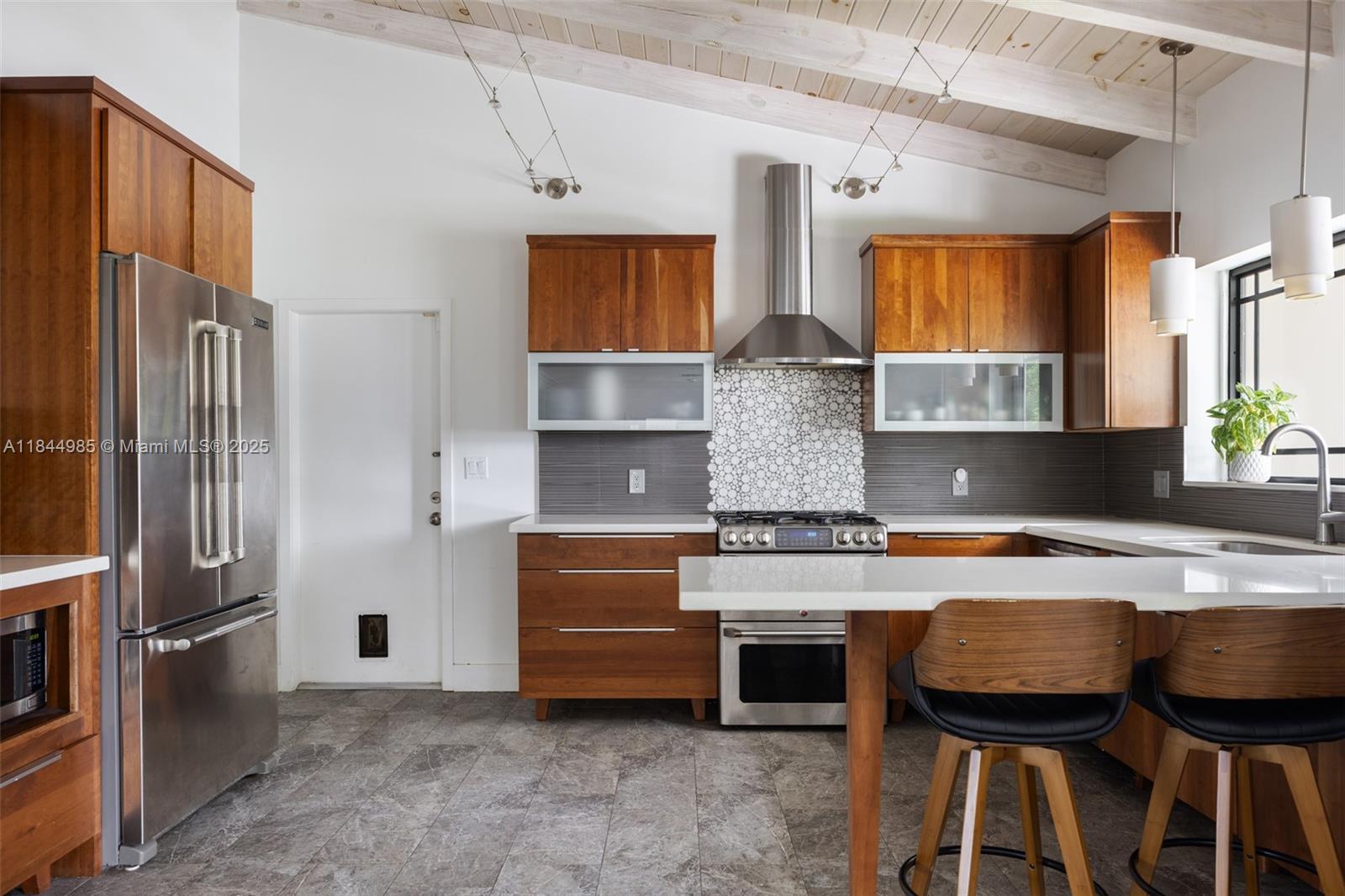 1080 Northeast 86th Street Miami, FL 33138 - Photo 3 of 25 a kitchen with stainless steel appliances granite countertop a stove refrigerator and a sink