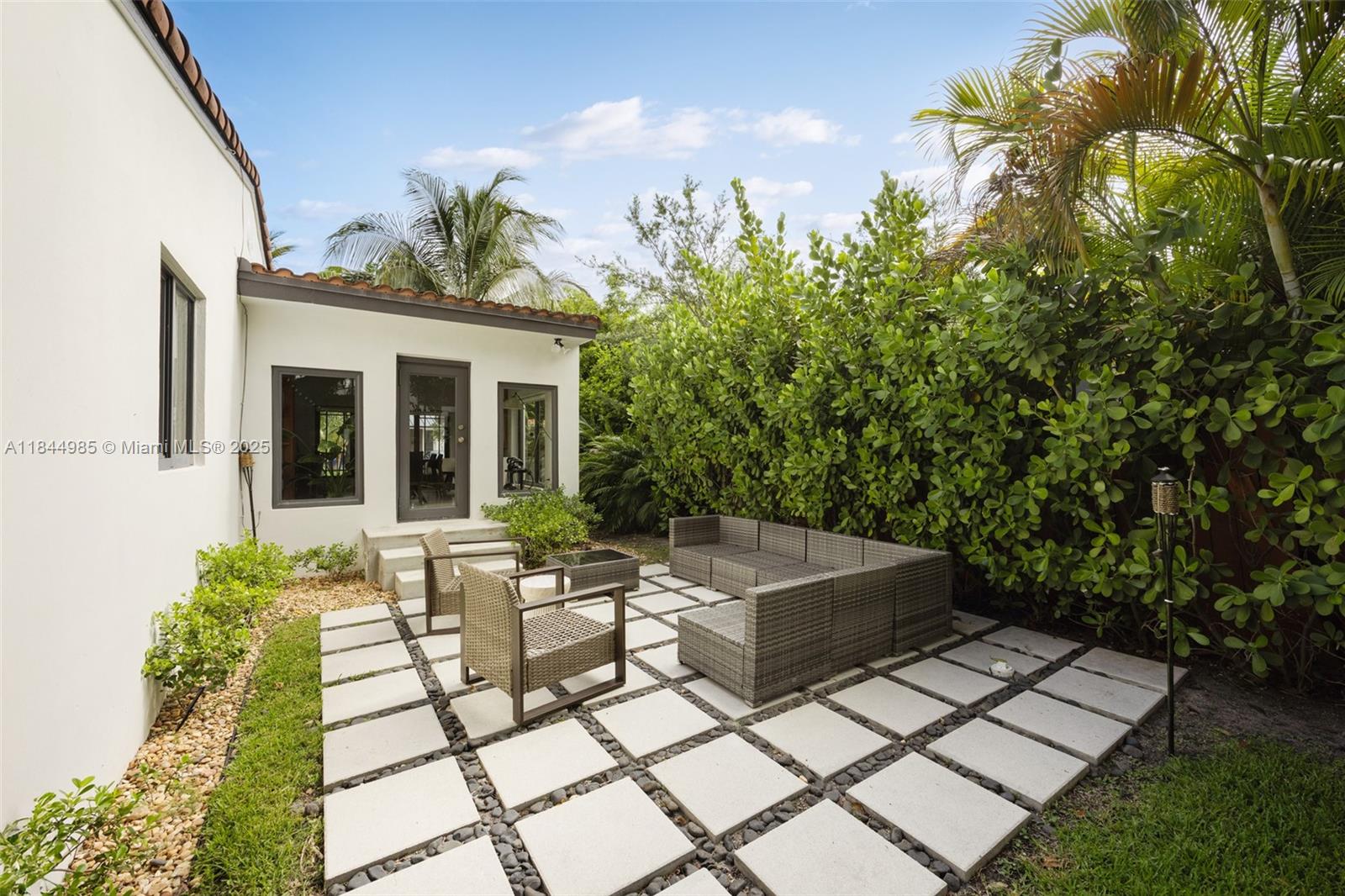 1080 Northeast 86th Street Miami, FL 33138 - Photo 7 of 25 a view of a house with sitting area and garden