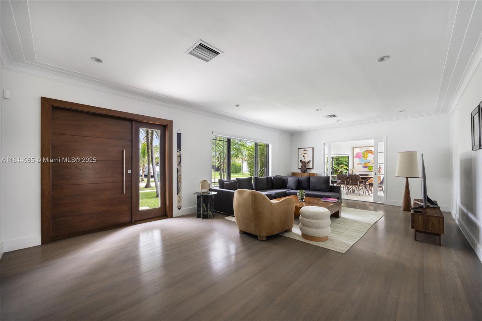 1080 Northeast 86th Street Miami, FL 33138 - Photo 10 of 25 a living room with furniture and a flat screen tv