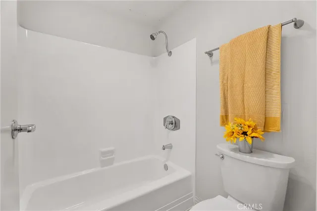 a bath room with a toilet and a bath tub