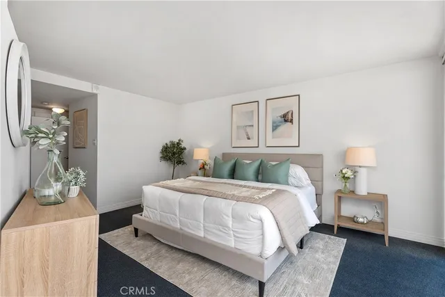 a bedroom with a bed and a lamp