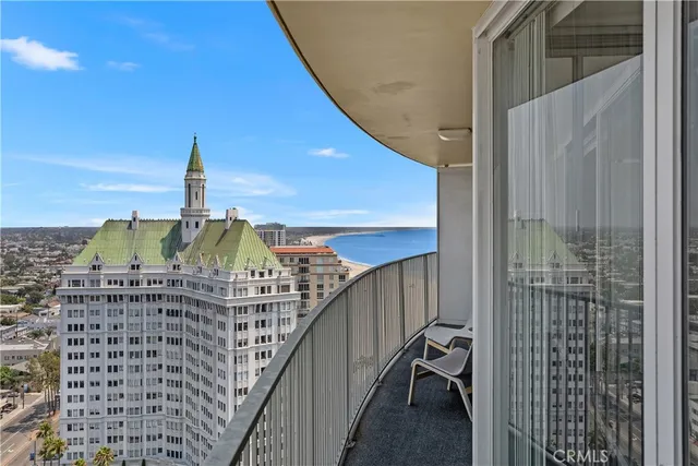a balcony with table and chairs
