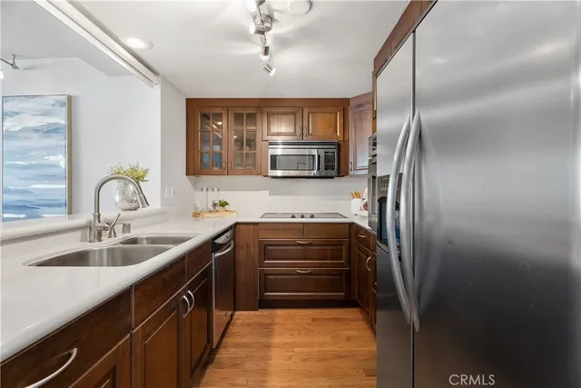 a kitchen with stainless steel appliances granite countertop a refrigerator and a sink