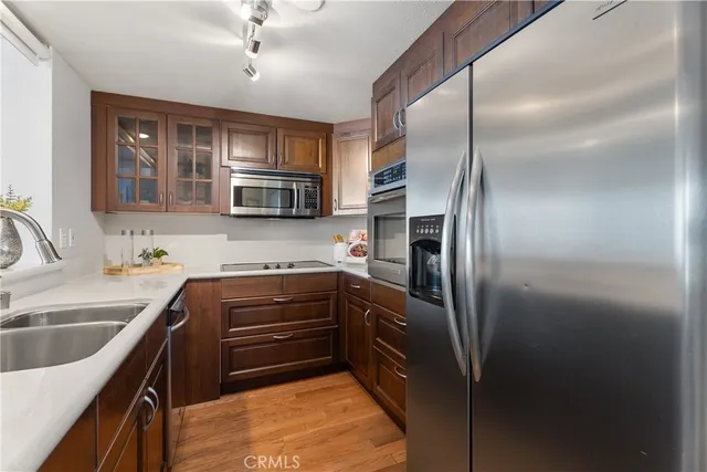 a kitchen with kitchen island a counter top space appliances and a sink