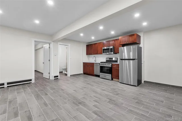 a kitchen with stainless steel appliances a refrigerator and a stove top oven