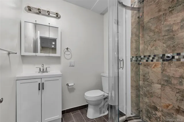 a view of kitchen with stainless steel appliances wooden floor and large window