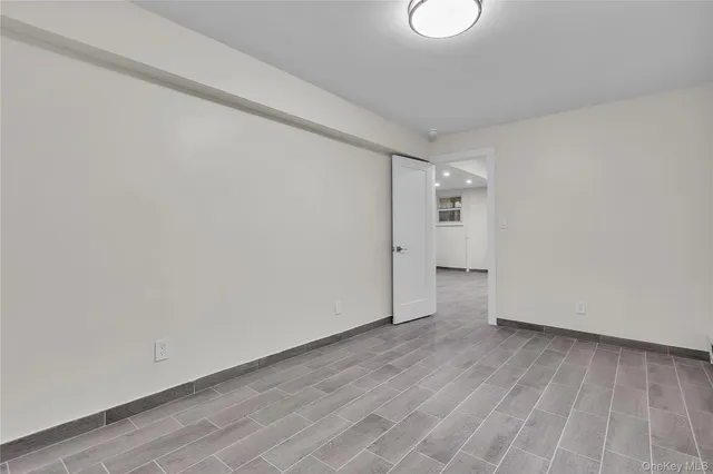 a bathroom with a granite countertop toilet a sink a mirror and vanity