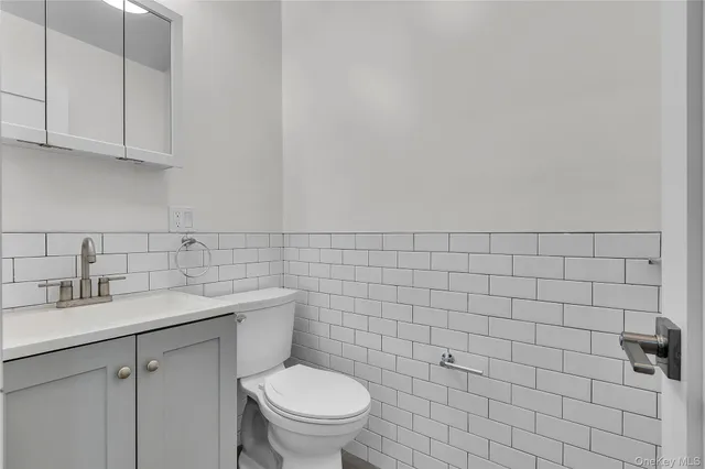 a kitchen with white cabinets stainless steel appliances and sink
