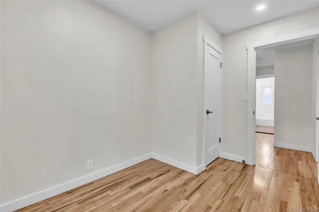 a view of an empty room and wooden floor