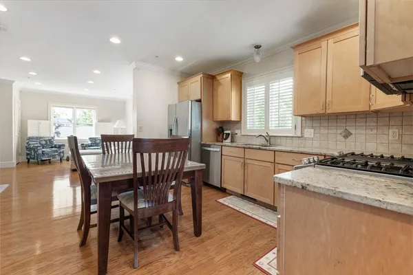 a kitchen with a table chairs stove and cabinets