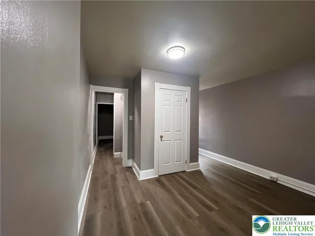 a view of hallway with wooden floor
