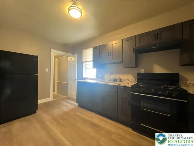 a kitchen with a stove and a refrigerator