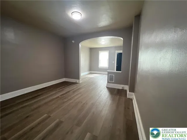 wooden floor in a hall with a window