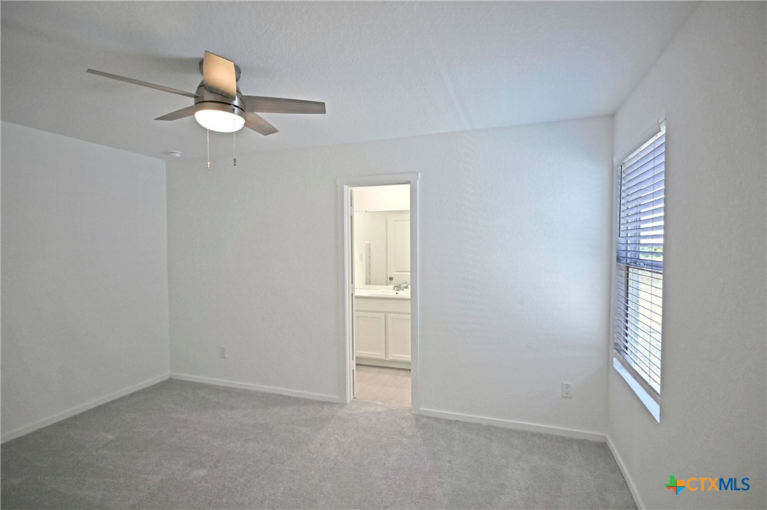 11822 Bluebell Ridge Converse, TX 78109 - Photo 11 of 24 an empty room with windows and fan