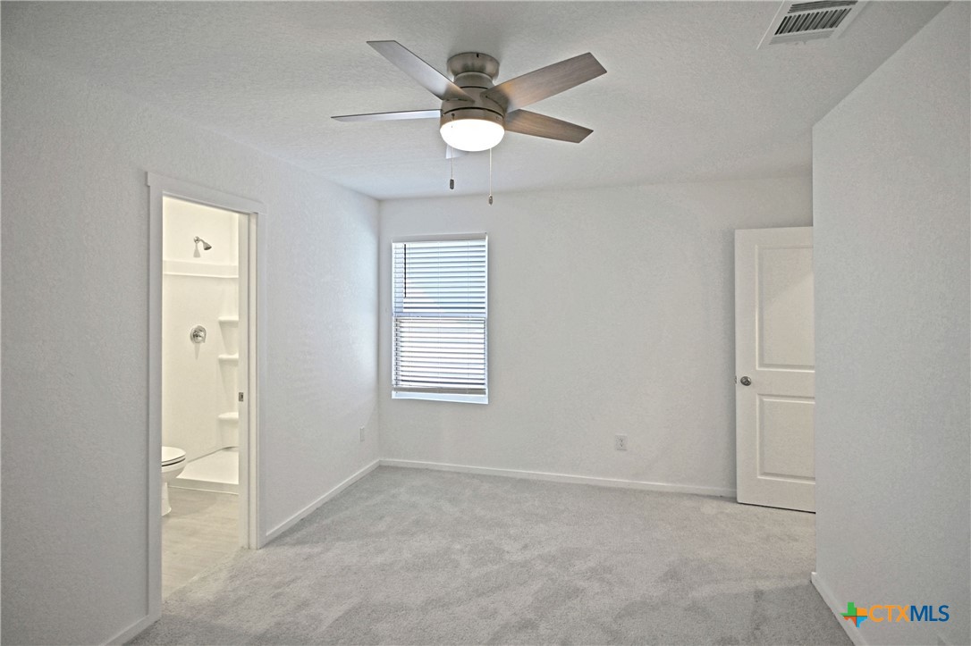 11822 Bluebell Ridge Converse, TX 78109 - Photo 13 of 24 an empty room with ceiling fan and window