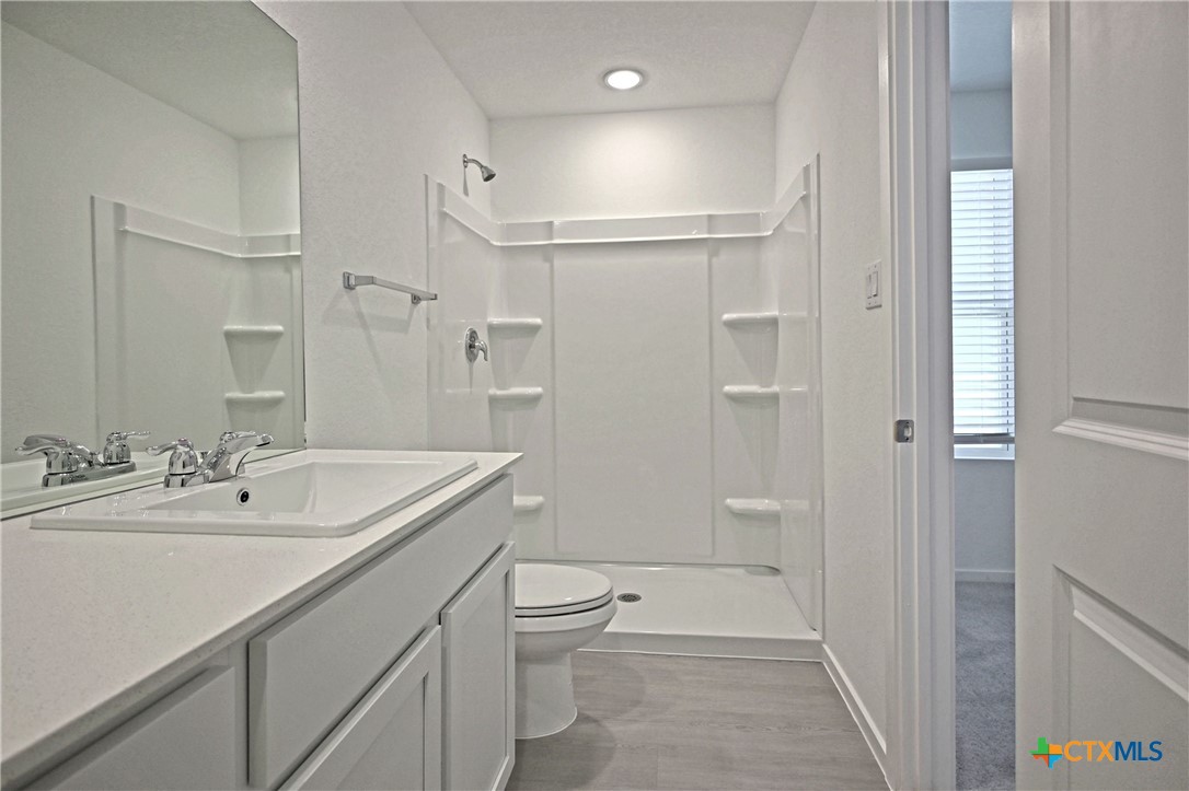 11822 Bluebell Ridge Converse, TX 78109 - Photo 15 of 24 a bathroom with a sink a toilet a tub and shower