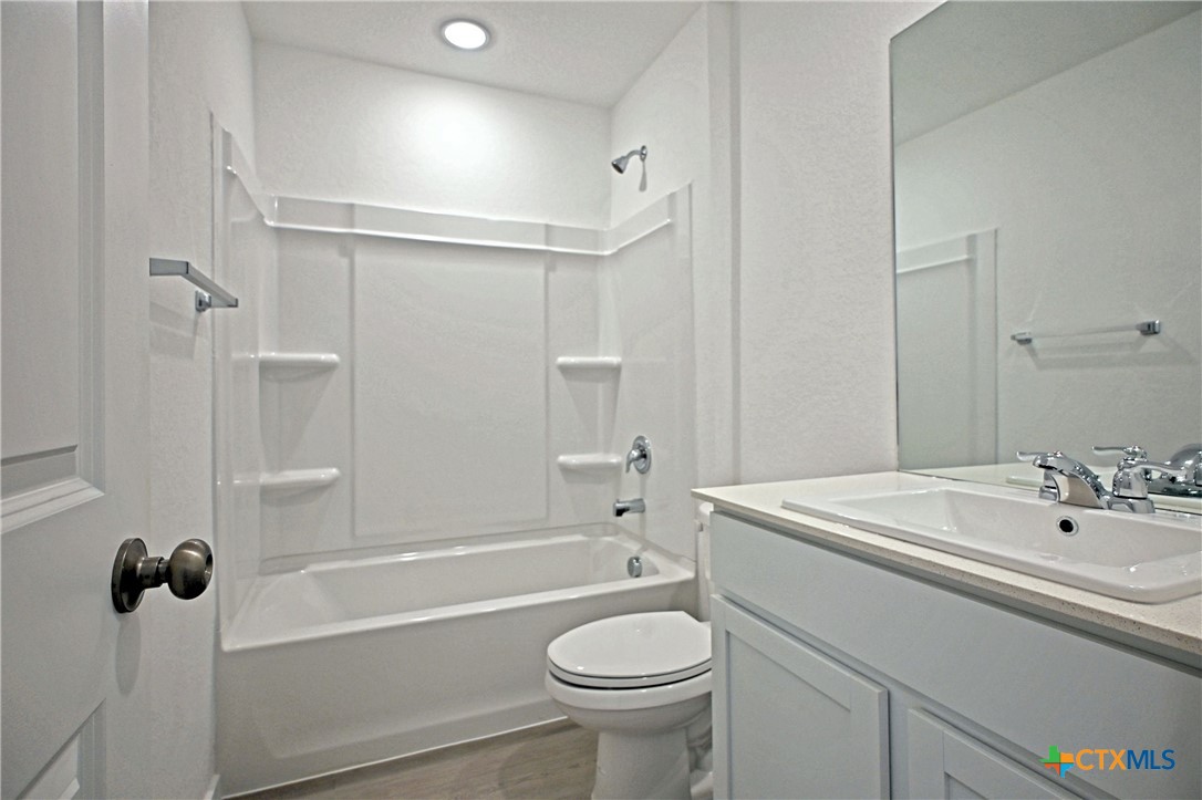 11822 Bluebell Ridge Converse, TX 78109 - Photo 20 of 24 a bathroom with a sink a toilet and shower