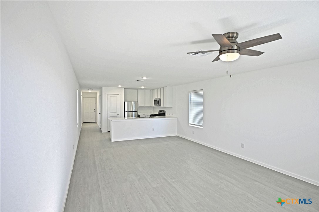 11822 Bluebell Ridge Converse, TX 78109 - Photo 7 of 24 a view of a livingroom with a ceiling fan and window
