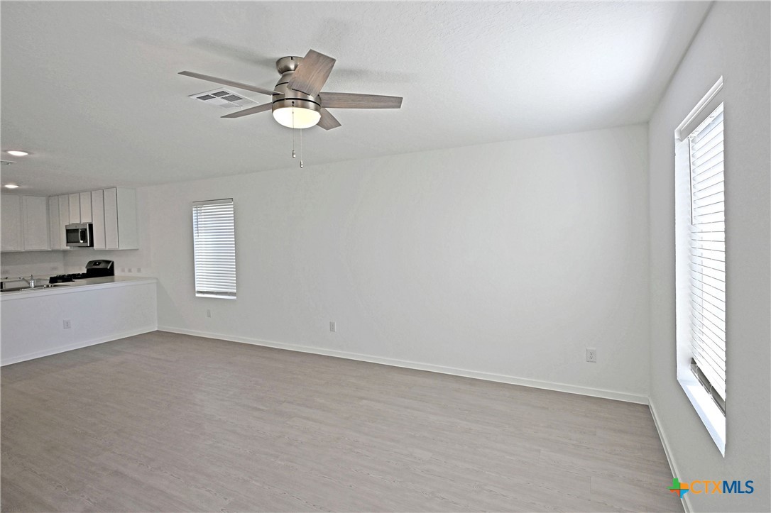 11822 Bluebell Ridge Converse, TX 78109 - Photo 8 of 24 a view of empty room with window and ceiling fan