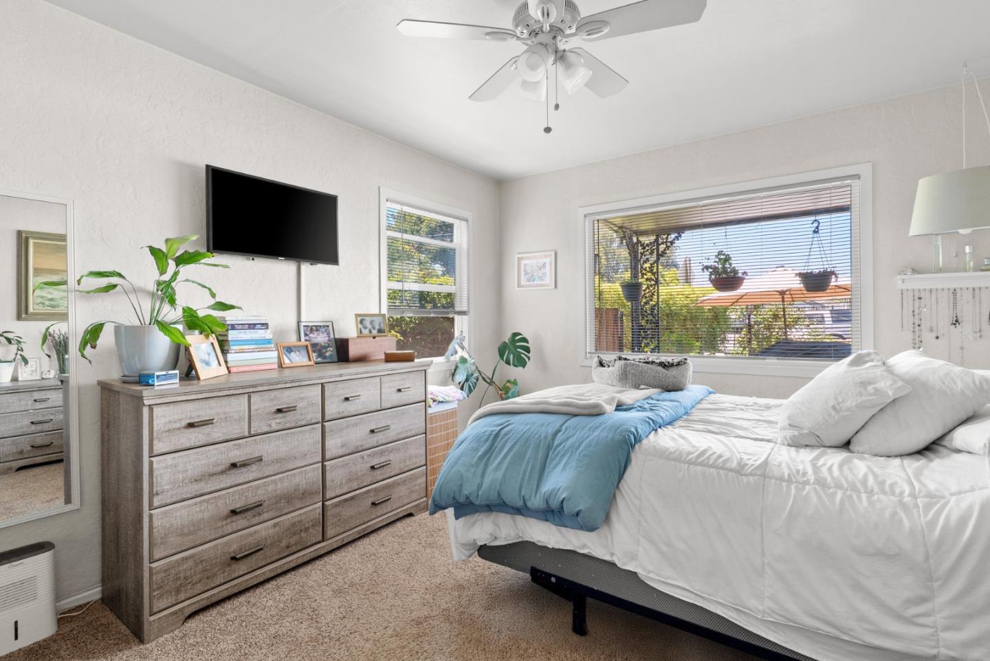 1450 Merrill Street Santa Cruz, CA 95062 - Photo 11 of 21 a bedroom with a large bed and a flat tv screen on dresser