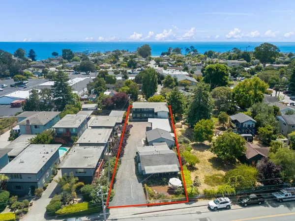 an aerial view of residential houses with outdoor space