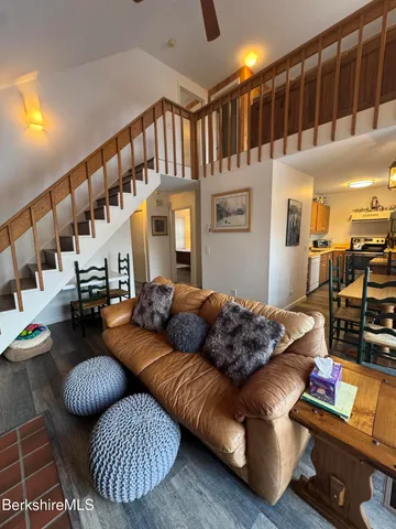 a living room with furniture fireplace and a table