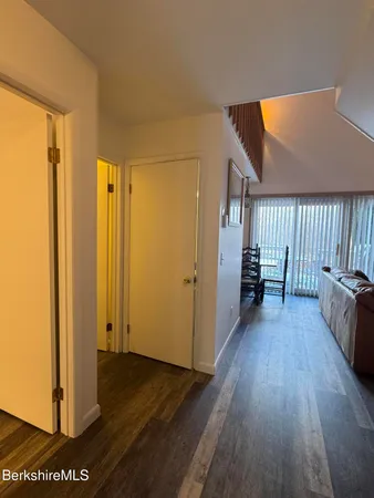 a view of a room with wooden floor