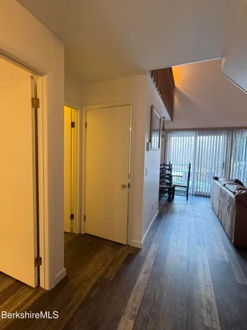 a view of a room with wooden floor