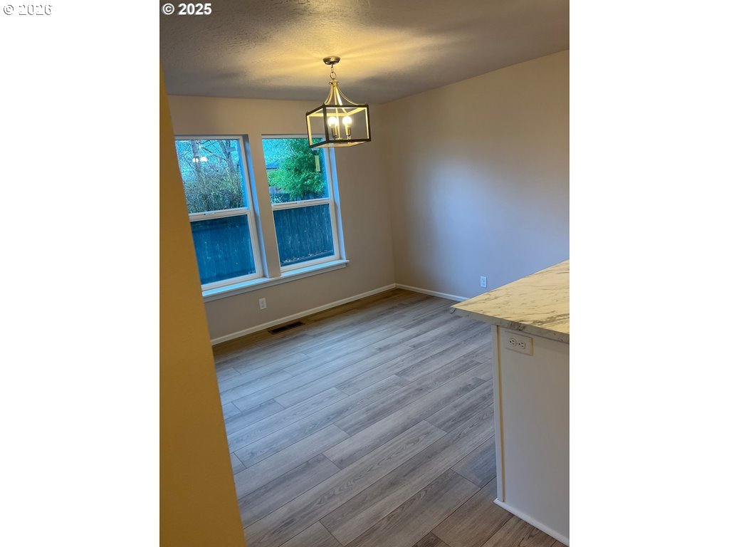 529 Helen Street Eugene, OR 97404 - Photo 4 of 9 a view of a room with wooden floor and a window