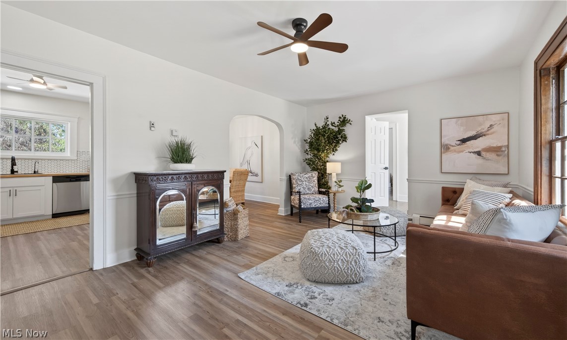14939 Caves Road Novelty, OH 44072 - Photo 5 of 42 Living room with ceiling fan, arched walkways, and wood finished floors