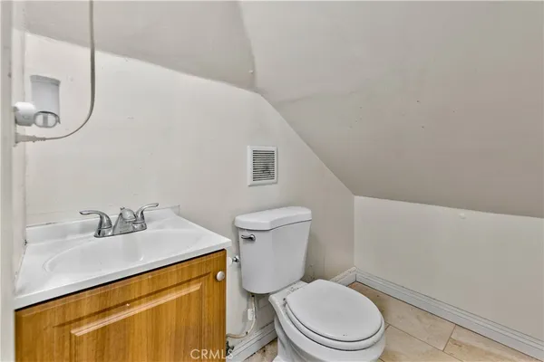 a white toilet sitting next to a bathroom sink