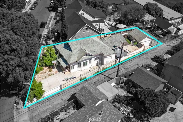 an aerial view of a house with a yard and potted plants