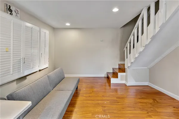 a view of entryway and hall with wooden floor