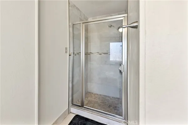 a bathroom with a glass shower door