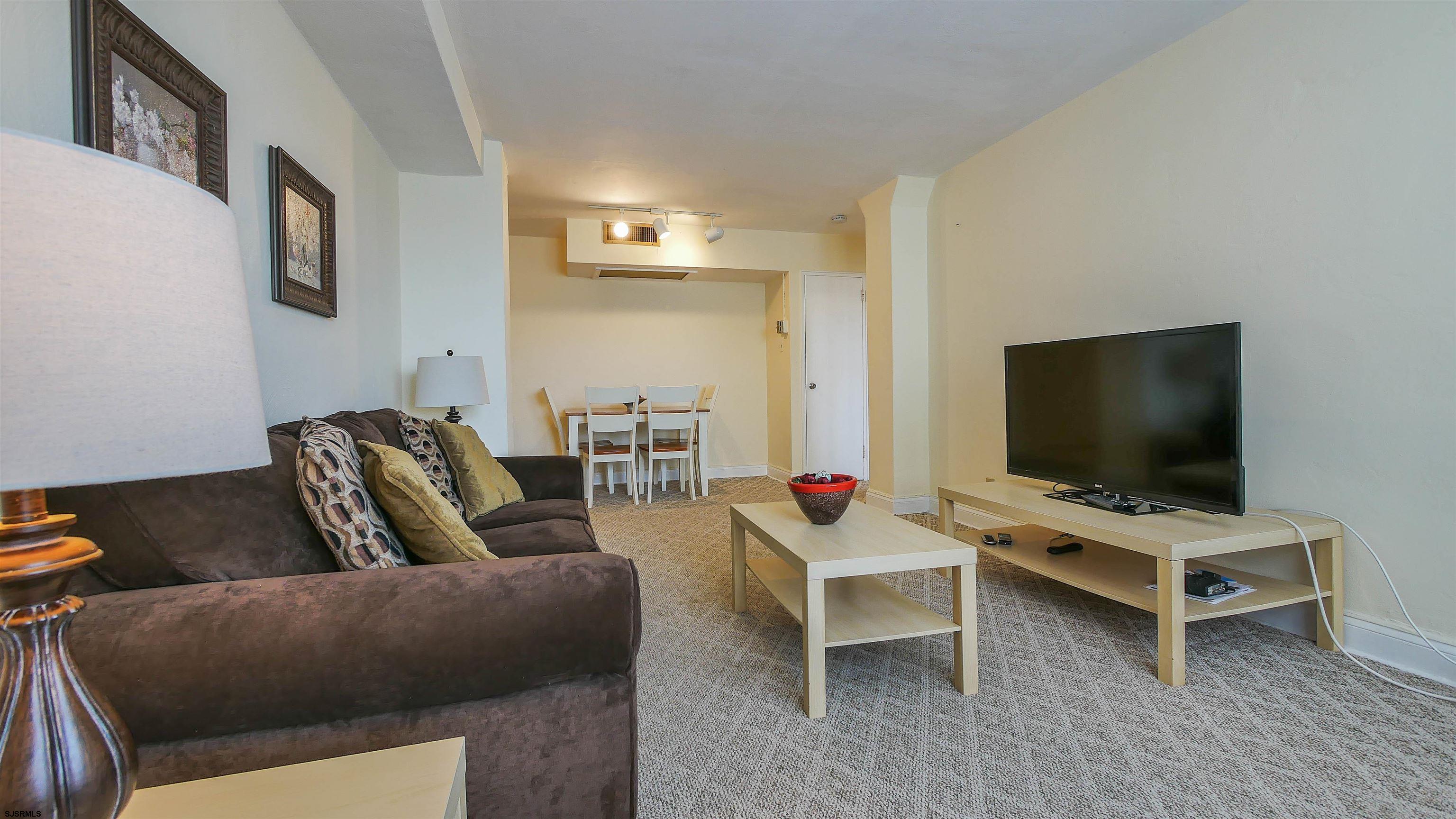 101 South Raleigh Avenue, Unit 207 Atlantic City, NJ 08401 - Photo 14 of 30 a living room with furniture and a flat screen tv