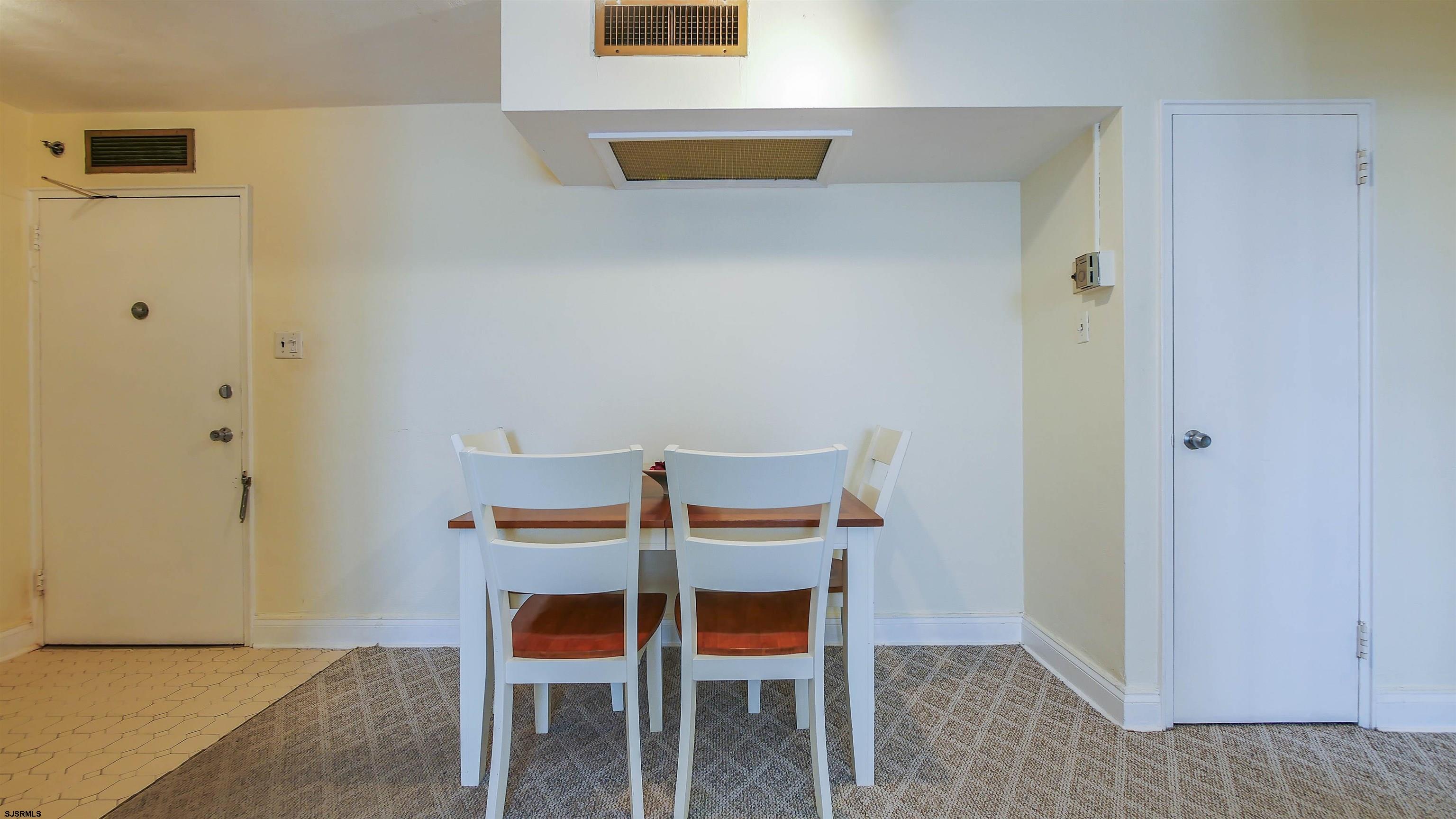 101 South Raleigh Avenue, Unit 207 Atlantic City, NJ 08401 - Photo 15 of 30 a room with a table and a chair