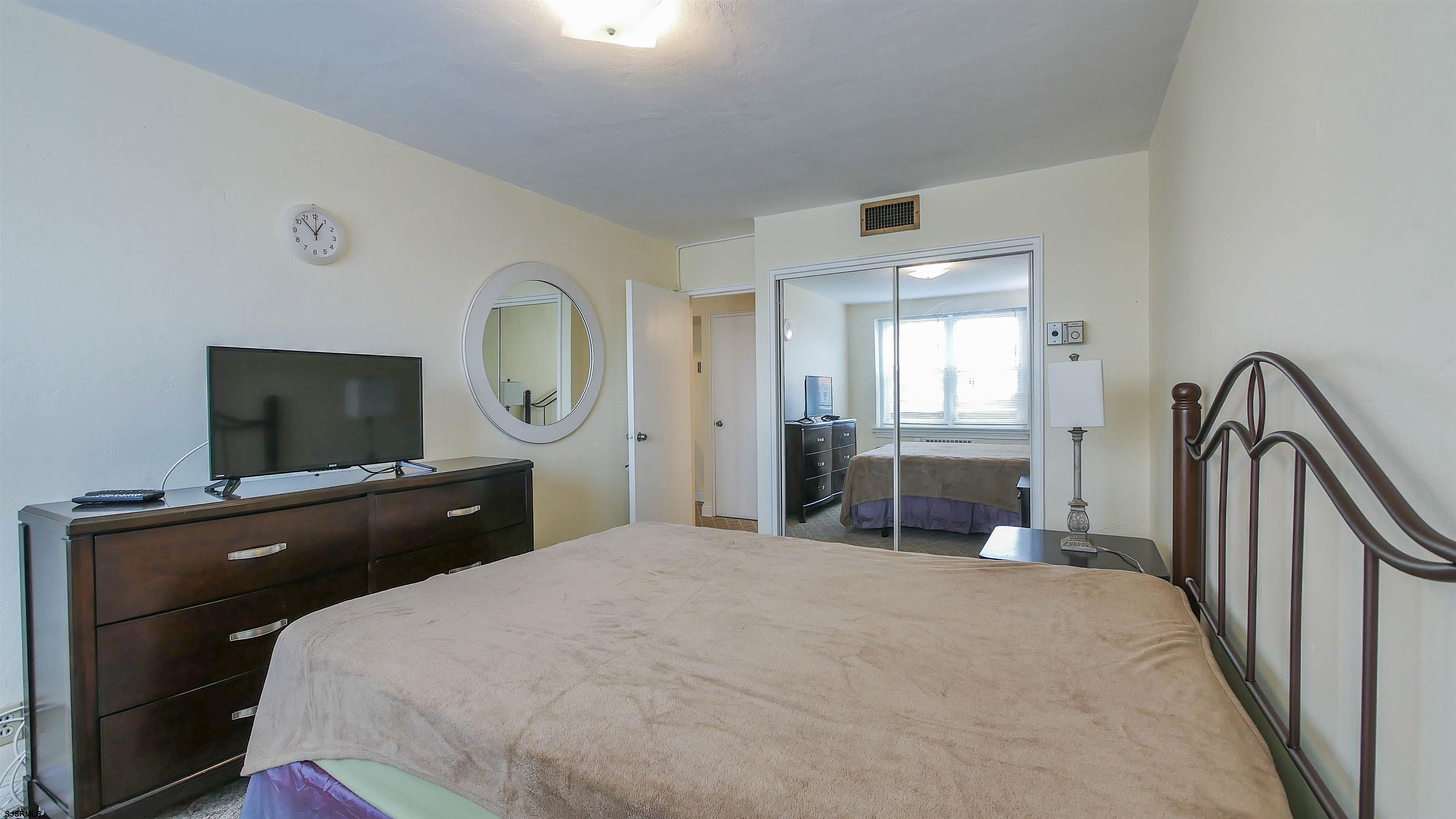 101 South Raleigh Avenue, Unit 207 Atlantic City, NJ 08401 - Photo 21 of 30 a bedroom with a bed and a flat screen tv
