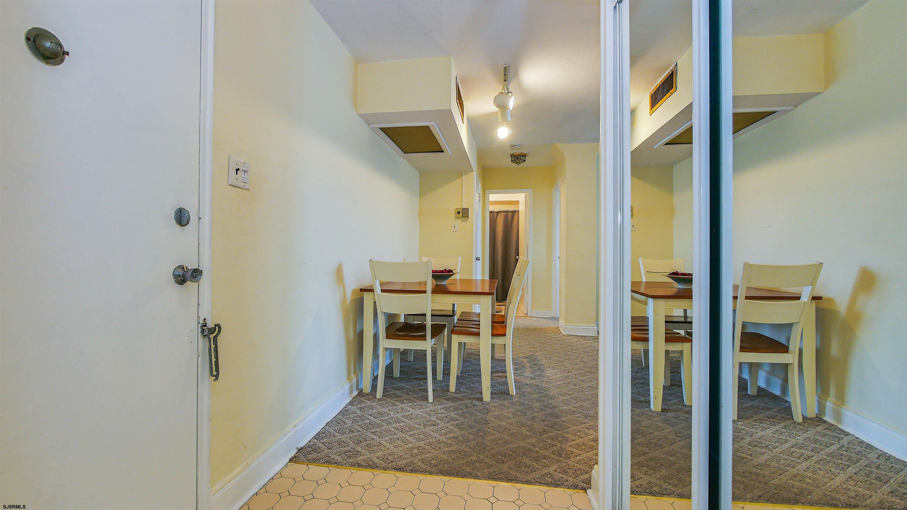 101 South Raleigh Avenue, Unit 207 Atlantic City, NJ 08401 - Photo 6 of 30 a view of a hallway with wooden floor windows and a bathroom