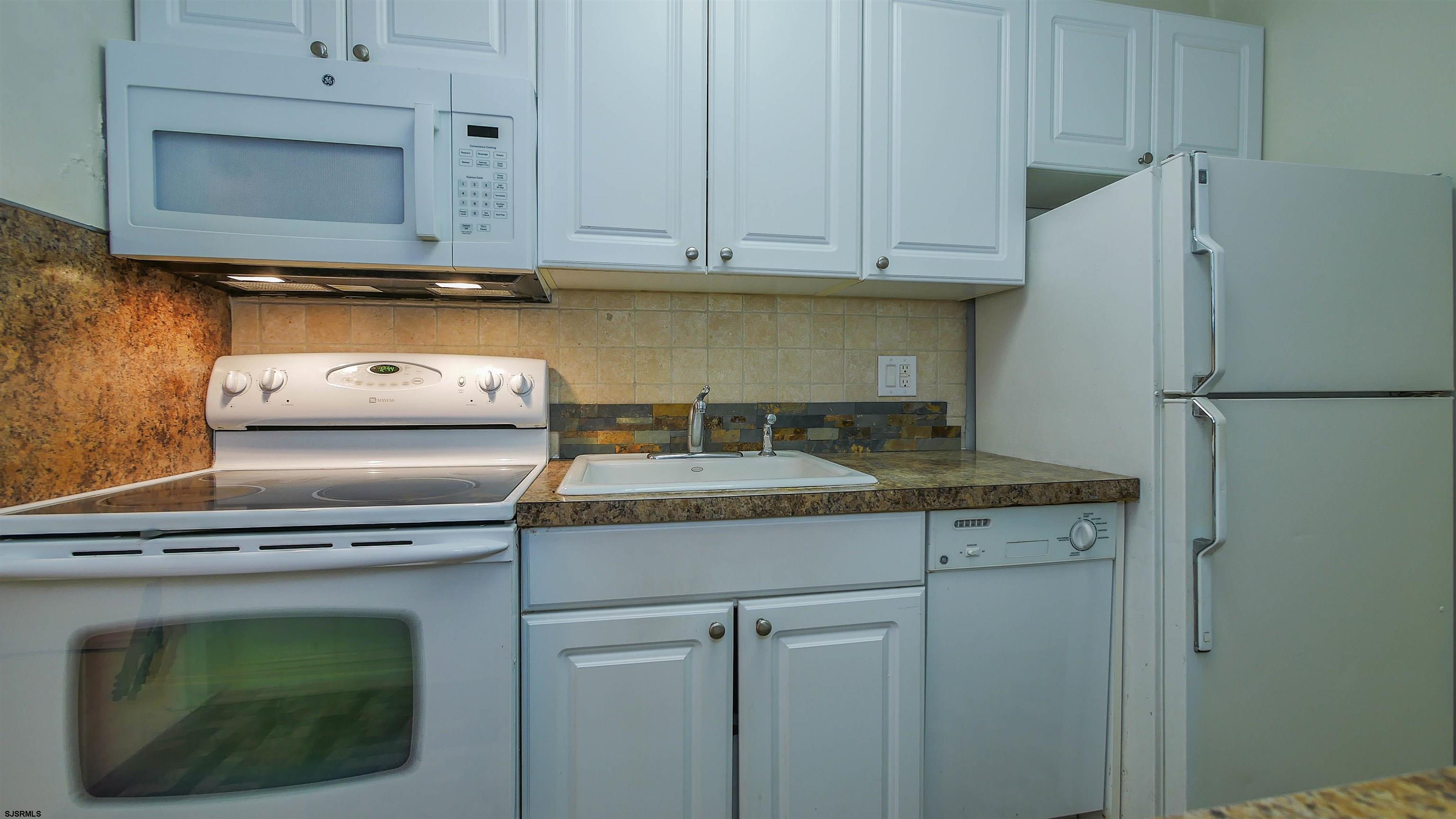 101 South Raleigh Avenue, Unit 207 Atlantic City, NJ 08401 - Photo 10 of 30 a kitchen with granite countertop cabinets stainless steel appliances and a counter space